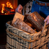 Basket of kiln dried Alder logs beside an open fire
